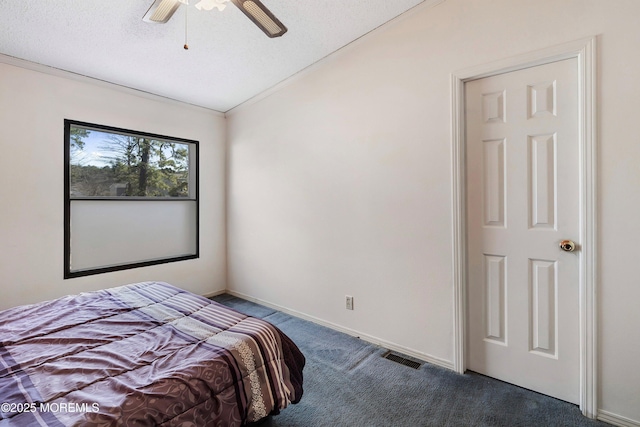 carpeted bedroom with visible vents, a ceiling fan, baseboards, and a textured ceiling