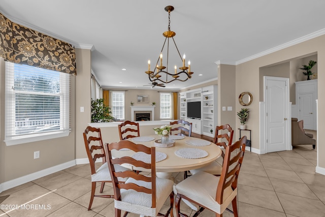 dining area with light tile patterned floors, a notable chandelier, a lit fireplace, and crown molding