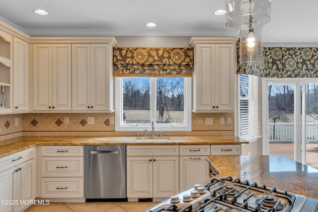 kitchen featuring a sink, light stone counters, cream cabinets, and light tile patterned floors