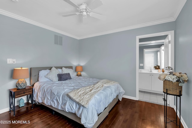 bedroom with visible vents, ornamental molding, hardwood / wood-style flooring, ensuite bath, and baseboards