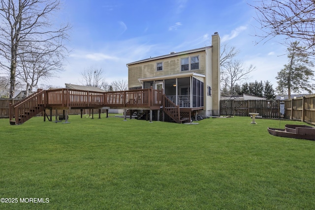 back of property featuring stairs, a sunroom, a chimney, a yard, and a fenced backyard