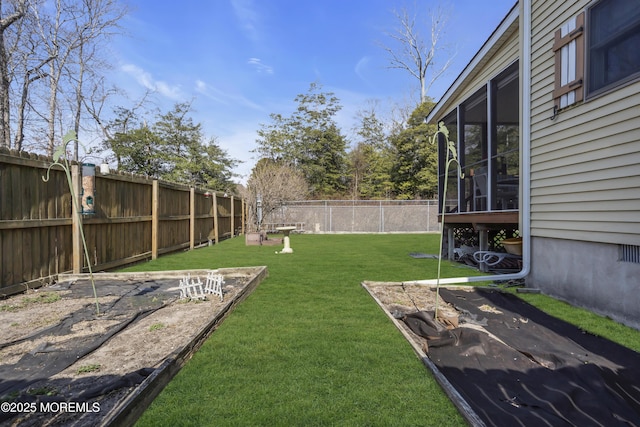 view of yard with a fenced backyard and a sunroom