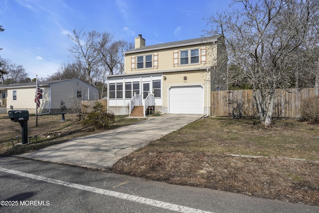 view of front facade featuring fence, an attached garage, a sunroom, a chimney, and concrete driveway