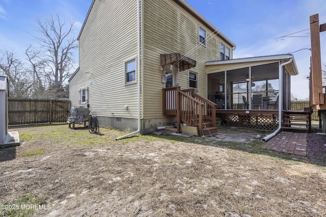 back of house featuring a patio, fence, a sunroom, and crawl space