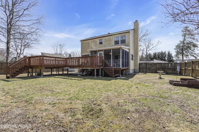 rear view of property featuring a chimney, a fenced backyard, stairs, and a sunroom