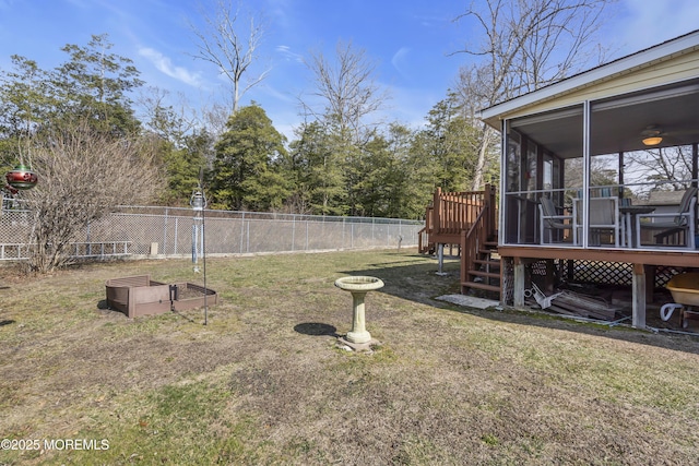 view of yard with stairs, fence, a sunroom, and a wooden deck