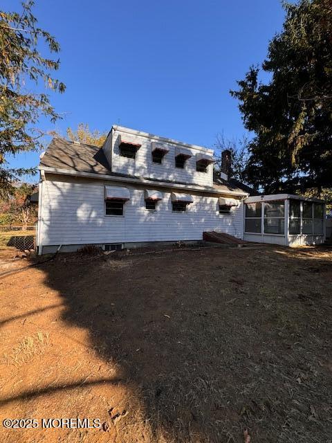 view of home's exterior with a sunroom