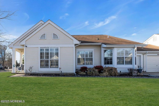 exterior space with a front lawn and an attached garage