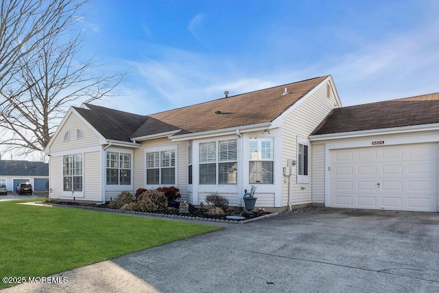 view of front of home featuring a garage, concrete driveway, and a front yard