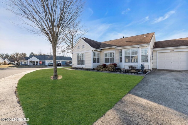 view of front of property with aphalt driveway, an attached garage, and a front lawn