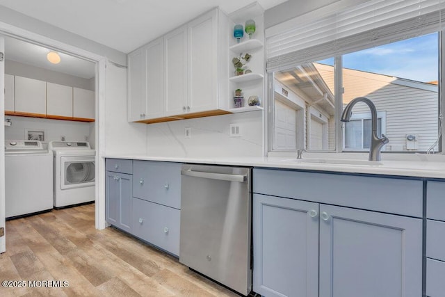 kitchen featuring open shelves, gray cabinets, stainless steel dishwasher, washing machine and dryer, and light wood-type flooring