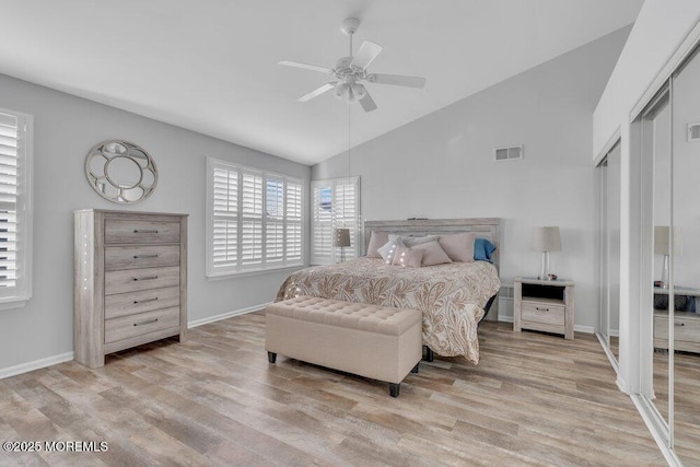 bedroom featuring lofted ceiling, wood finished floors, visible vents, and baseboards