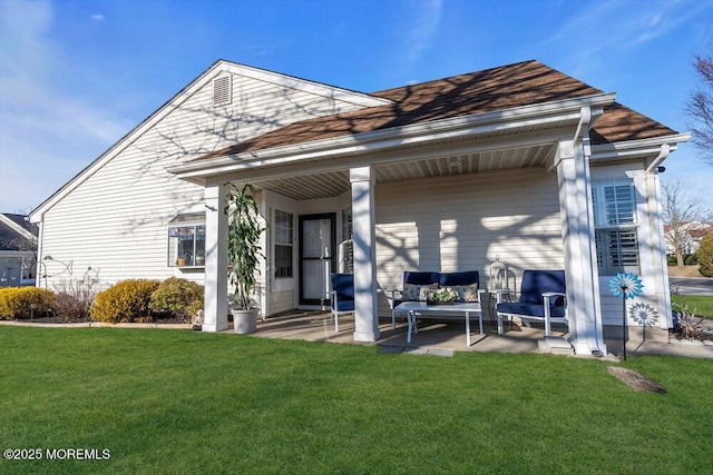 rear view of house with a yard and a patio area