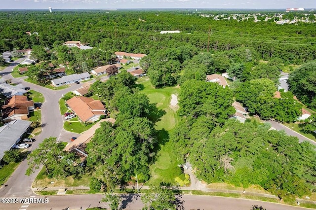 birds eye view of property with a wooded view