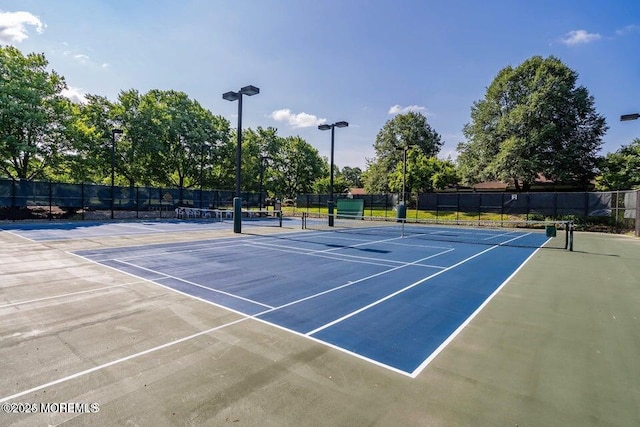 view of sport court featuring fence