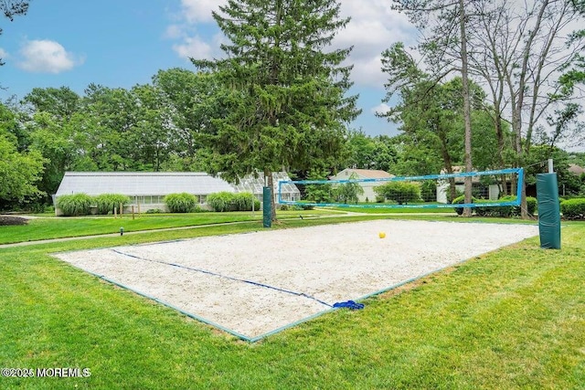 view of property's community with a yard and volleyball court