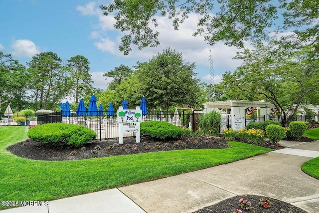 view of playground featuring fence and a lawn