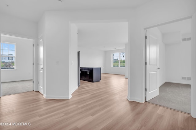 spare room featuring visible vents, baseboards, and light wood-style flooring