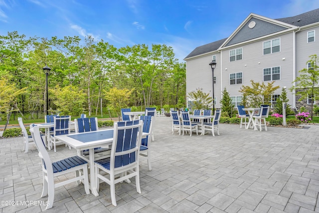 view of patio / terrace featuring outdoor dining area and fence