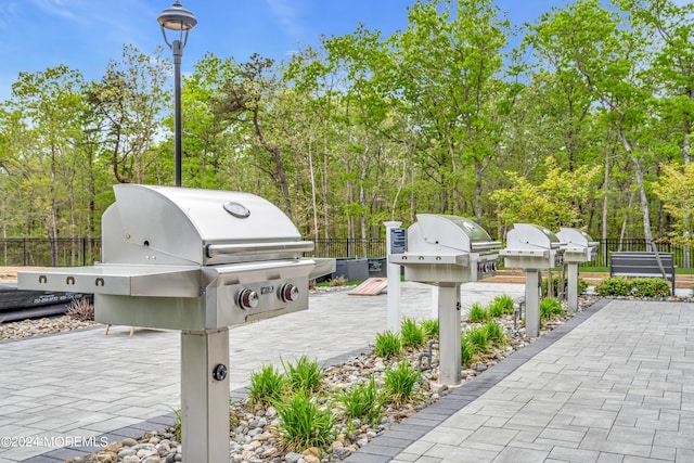 view of patio with a grill and fence