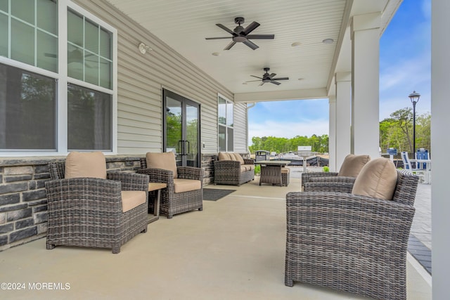 view of patio featuring an outdoor living space, french doors, and a ceiling fan