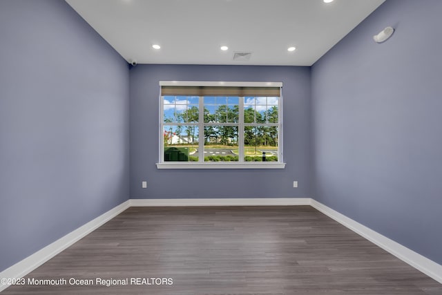 unfurnished room featuring recessed lighting, visible vents, baseboards, and wood finished floors