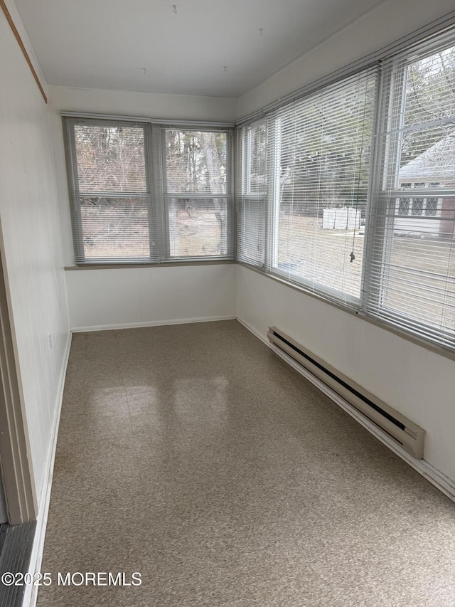 unfurnished sunroom featuring baseboard heating