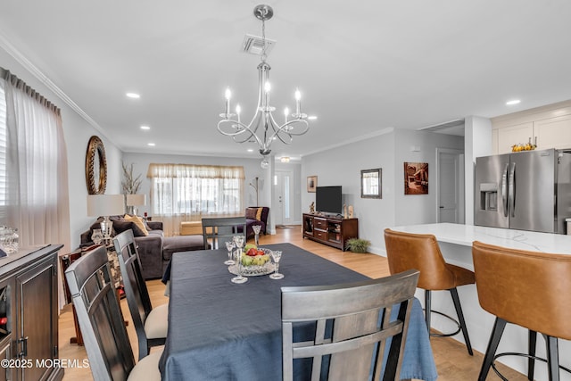 dining area with a notable chandelier, recessed lighting, visible vents, and ornamental molding