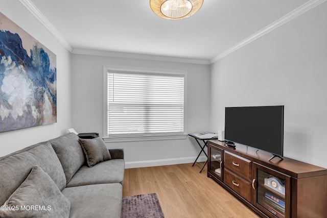 living room featuring baseboards, crown molding, and light wood finished floors