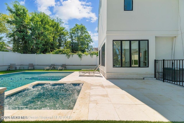 view of pool with an in ground hot tub, a fenced backyard, and a patio