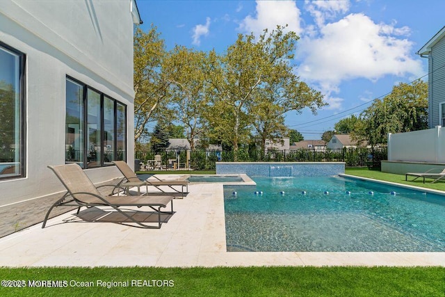 view of swimming pool with a patio area, a fenced in pool, and fence