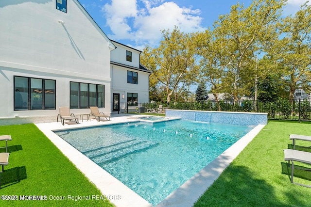 view of pool with a patio, a yard, fence, and a pool with connected hot tub