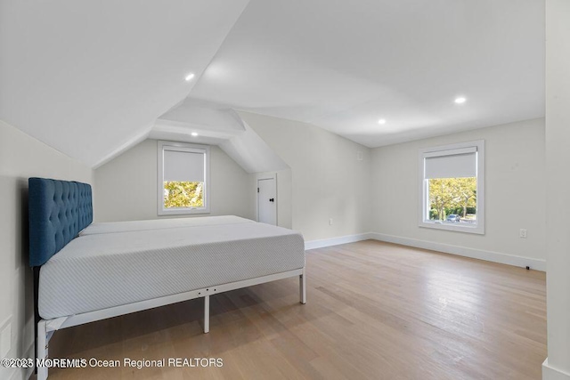 bedroom featuring recessed lighting, baseboards, lofted ceiling, and wood finished floors