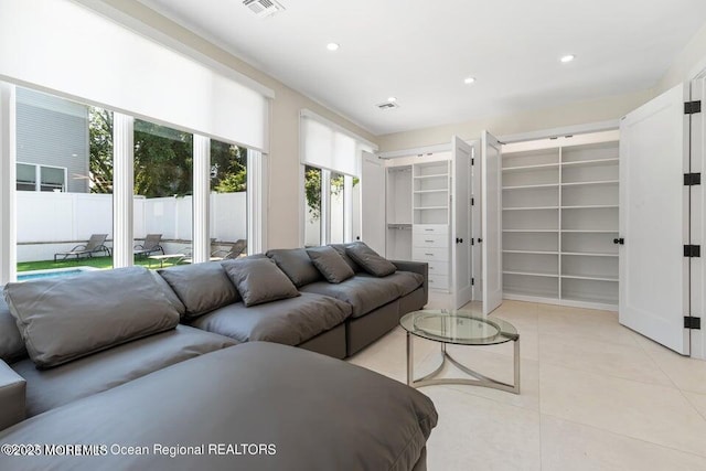 living room with light tile patterned floors, visible vents, and recessed lighting