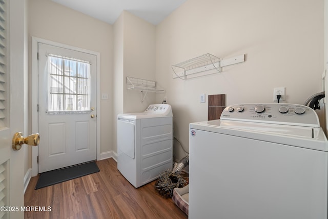 laundry room with laundry area, wood finished floors, baseboards, and washer and clothes dryer