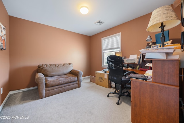 carpeted office with baseboards and visible vents