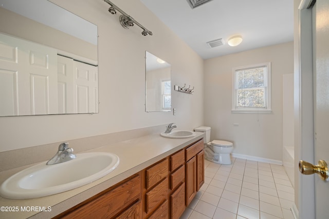 bathroom with a sink, visible vents, toilet, and tile patterned flooring