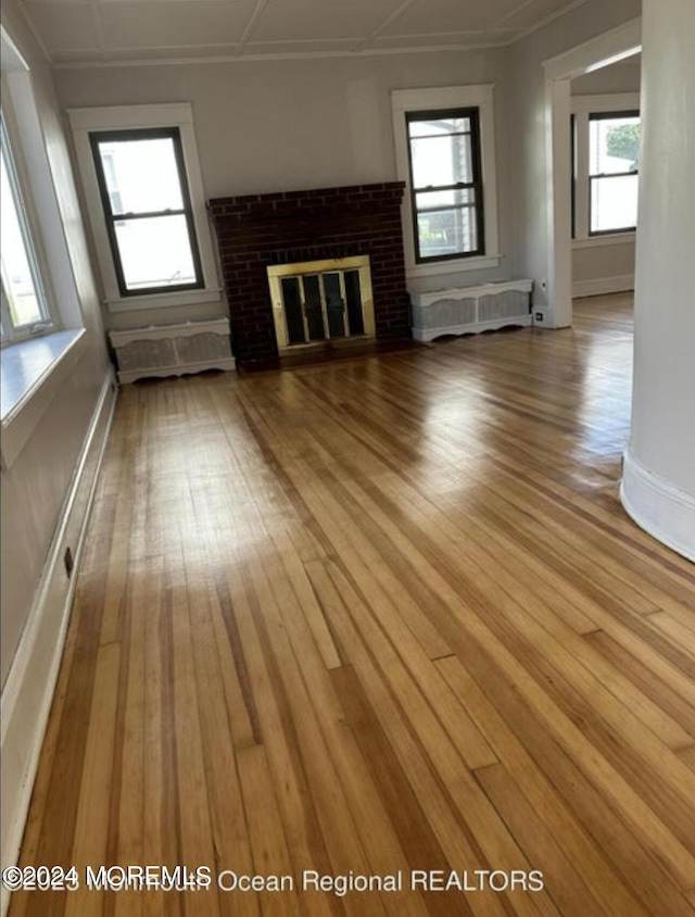 unfurnished living room with a fireplace and wood-type flooring