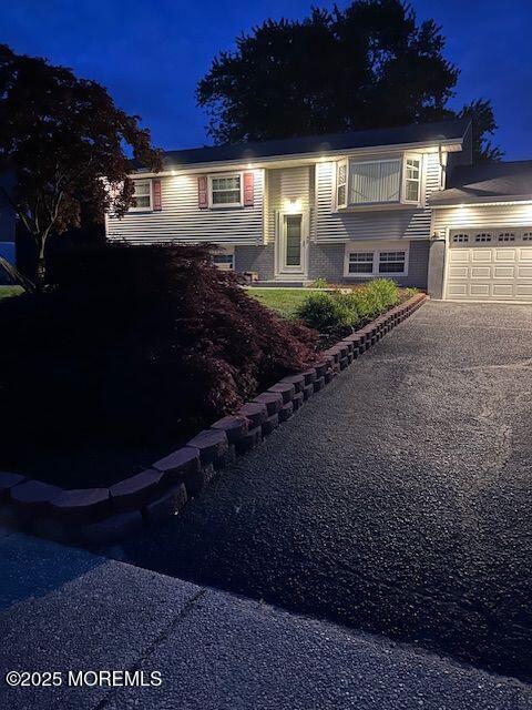 split foyer home with a garage and driveway