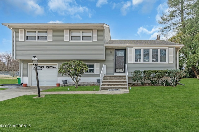 tri-level home with an attached garage, driveway, and a front yard