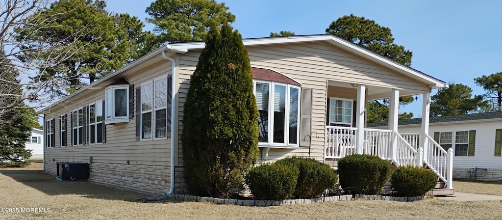 view of property exterior with a porch and central air condition unit