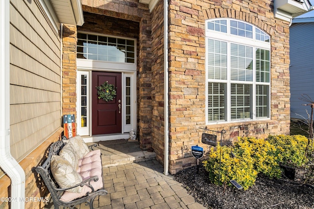 entrance to property featuring brick siding