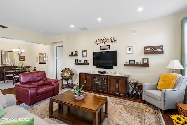 living room featuring recessed lighting, wood finished floors, visible vents, and a chandelier