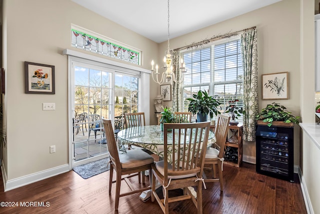 dining area featuring beverage cooler, a notable chandelier, baseboards, and wood finished floors