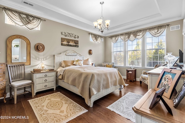 bedroom featuring visible vents, a raised ceiling, dark wood finished floors, and a chandelier