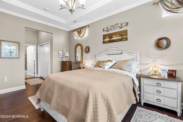 bedroom with dark wood finished floors, a chandelier, crown molding, and baseboards