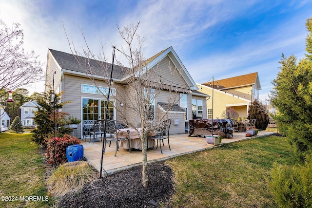 back of property featuring a yard and a patio