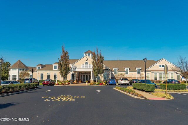 view of front of house with a residential view and uncovered parking