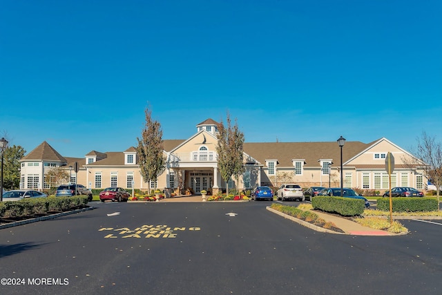 view of front of property with a residential view and uncovered parking