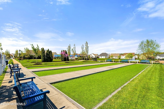 view of home's community with a residential view and a lawn